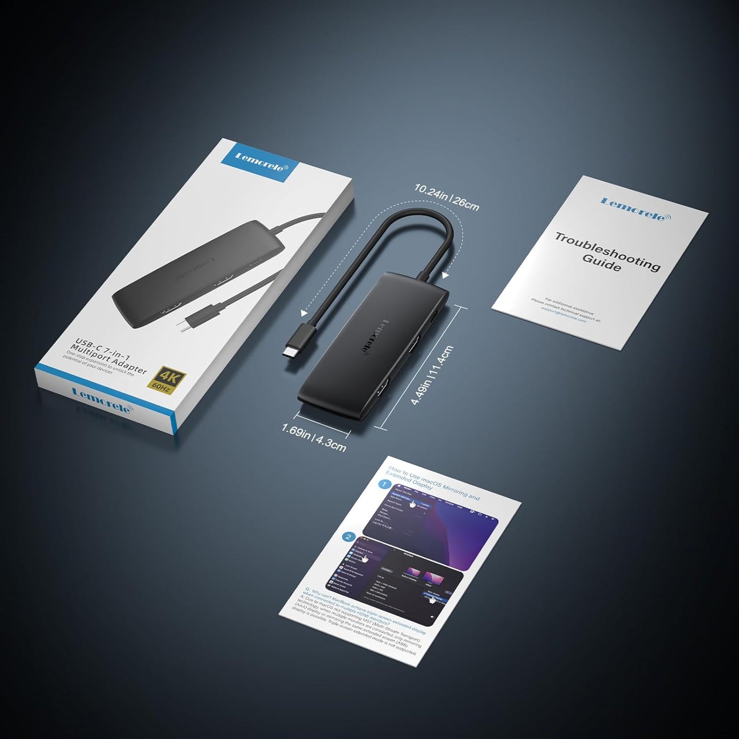 USB-C adapter with packaging, cable, and troubleshooting guide on a dark background