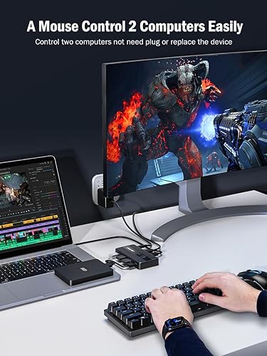 Person using a computer setup with a mouse control device, showing two monitors and a keyboard.