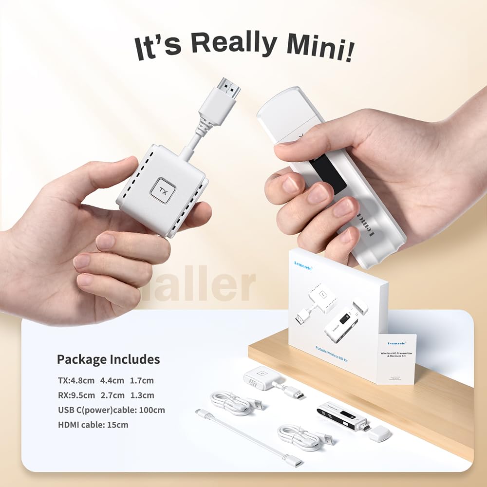 Two hands holding a mini electronic device with packaging and accessories on a wooden surface.