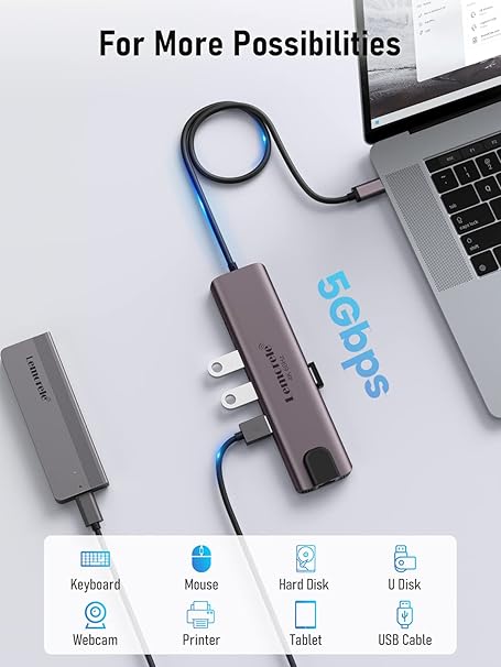 USB hub with multiple ports connected to a laptop on a light gray background