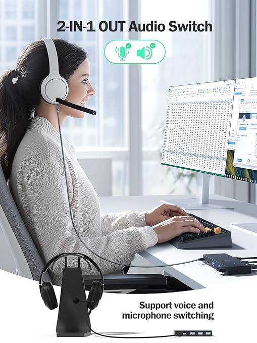 Person wearing a headset and using a computer with a 2-in-1 audio switch device.