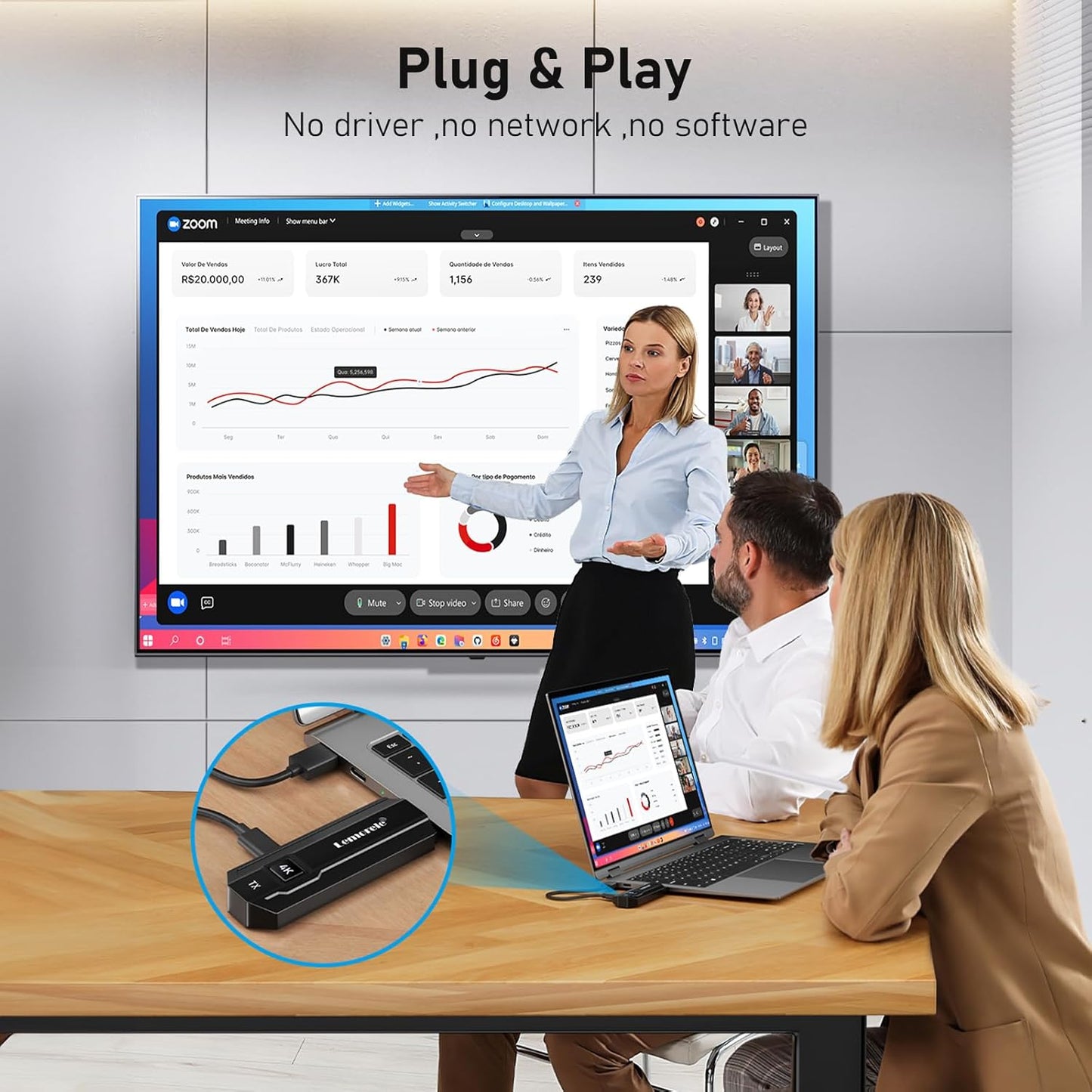 Person presenting on a large screen with two people at a desk using laptops, featuring 'Plug & Play' text.