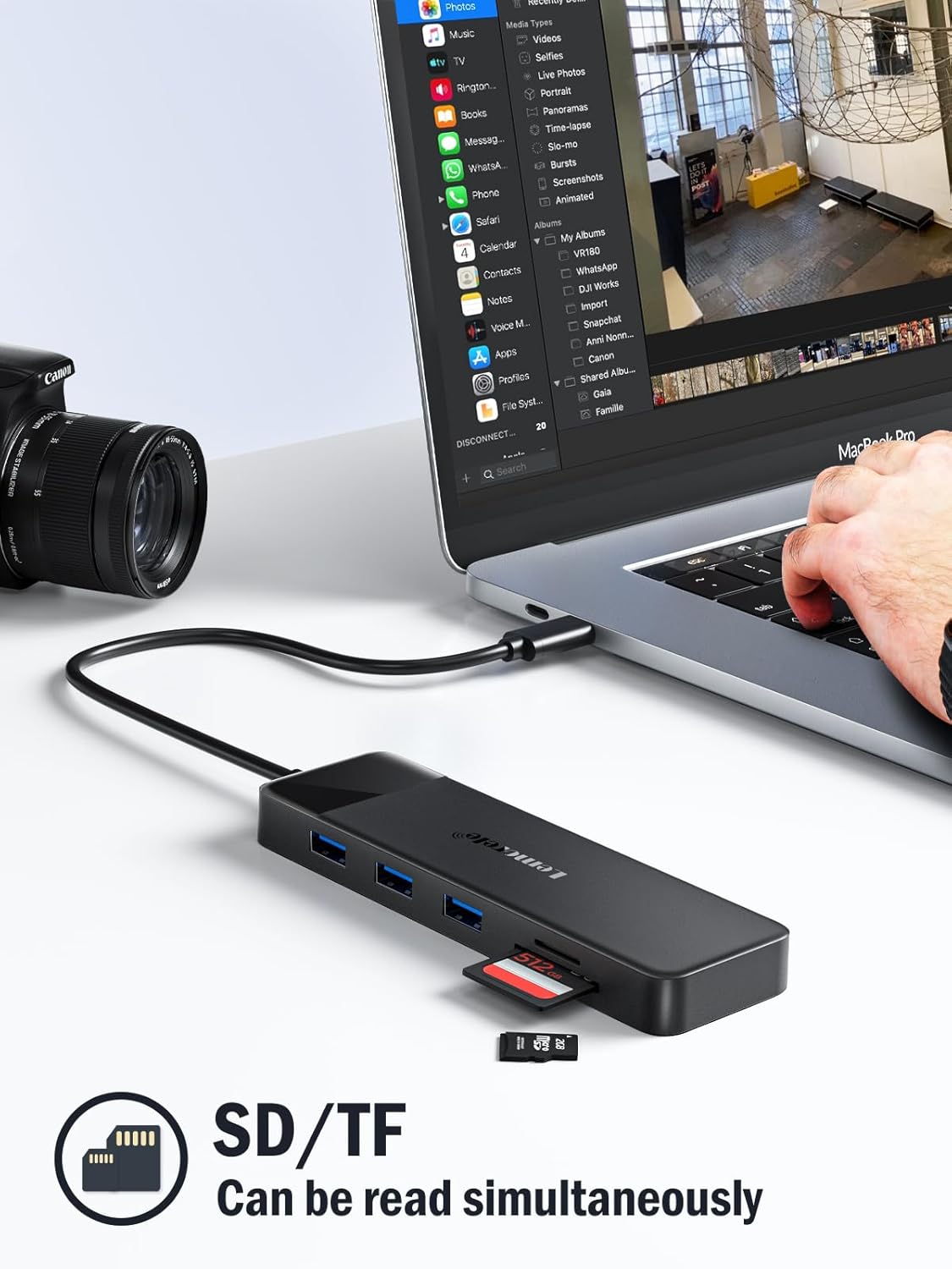 USB hub connected to a laptop with a camera on a white surface
