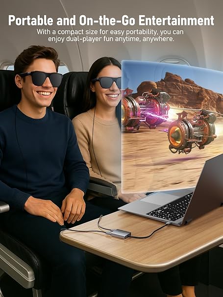 Two people using a portable entertainment system with a laptop and screen displaying a racing game.