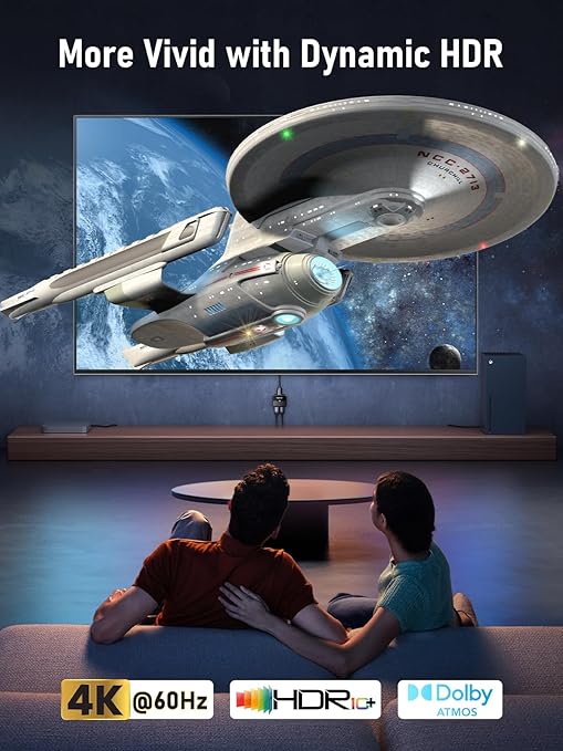 Two people watching a spaceship on a large screen with text about Dynamic HDR, 4K resolution, and Dolby Atmos.