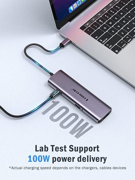 Laptop with a USB-C hub connected, displaying 100W power delivery on a white background.