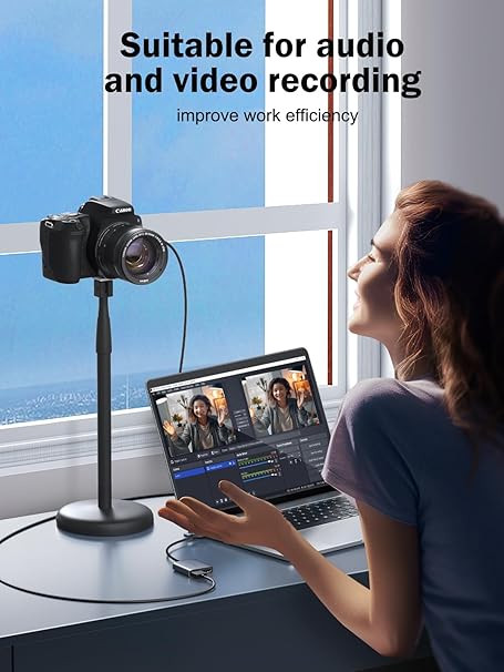 Person using a laptop with video editing software, next to a camera on a stand, suitable for audio and video recording.