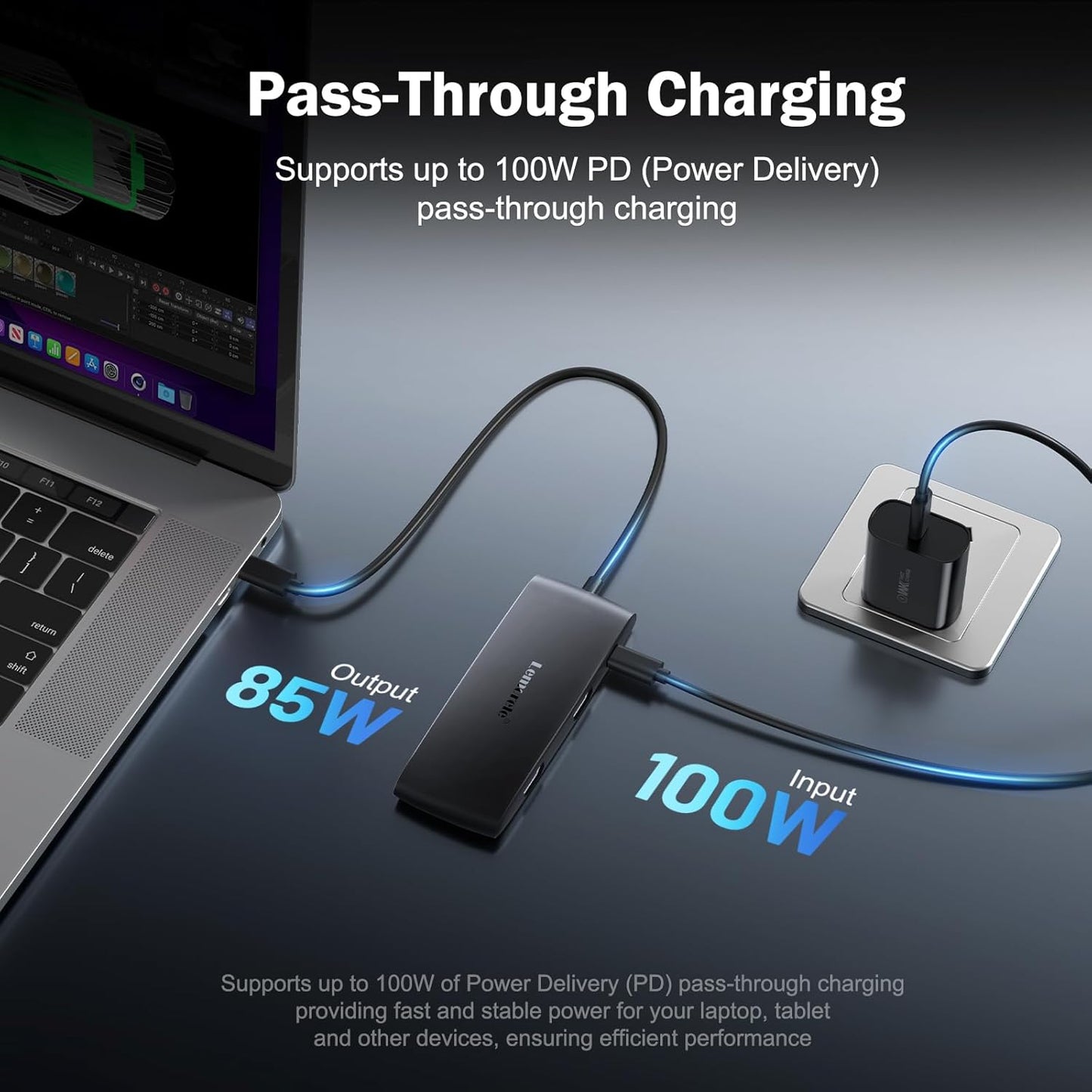 Pass-through charging device with laptop and power adapter on a dark surface