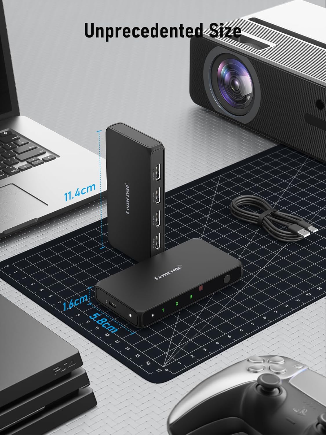 Black electronic device on a desk with computer equipment in the background