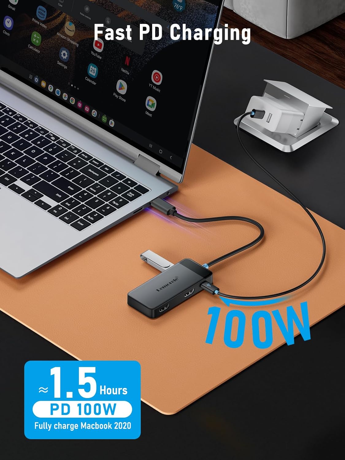 Laptop with a USB-C hub connected, charging a device on a desk.