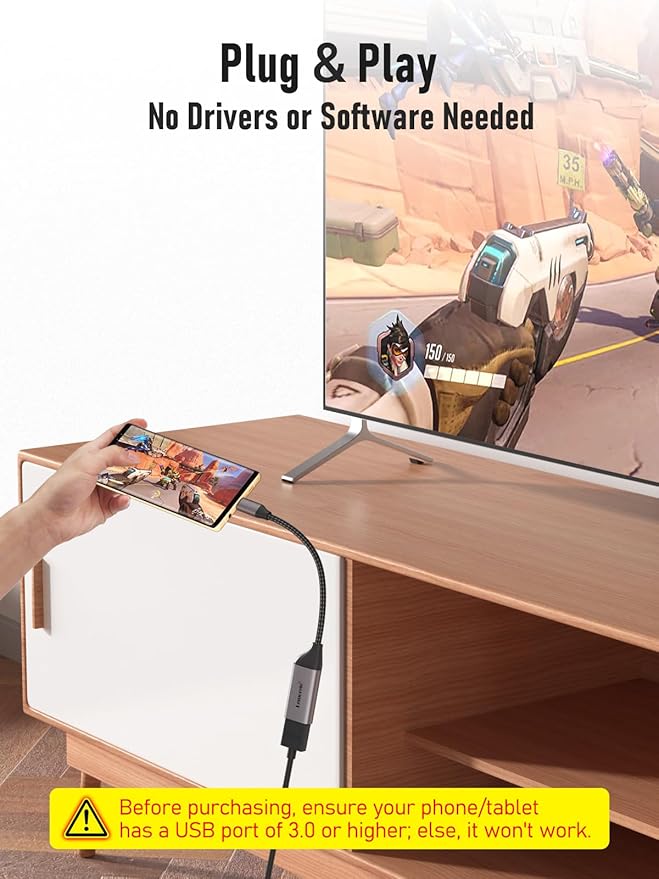 Gaming setup with TV, smartphone, and cable on a wooden desk.