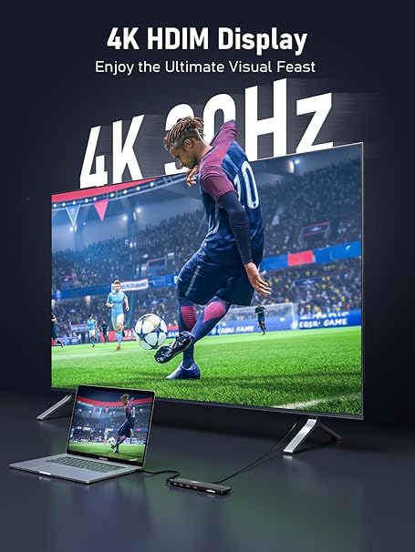 Large screen displaying a soccer game with '4K HDIM Display' text, laptop below showing same content.