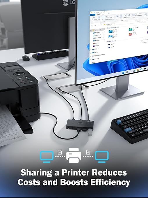 Computer setup with multiple monitors, printer, and keyboard on a desk with text about sharing a printer.