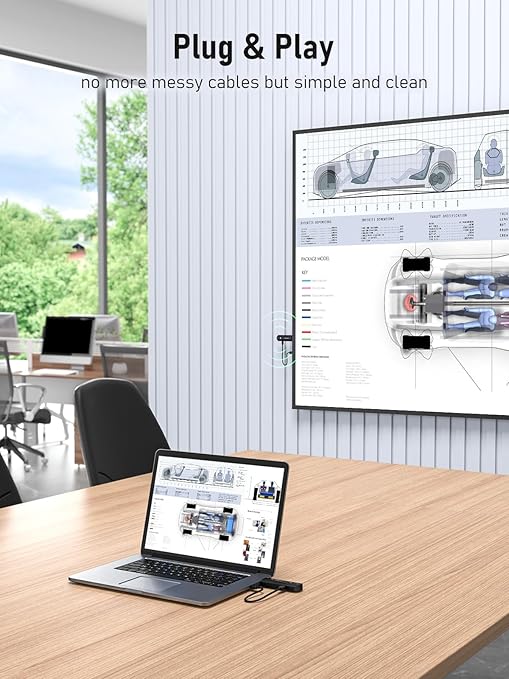 Laptop on a desk with a screen displaying technical drawings, in an office setting.